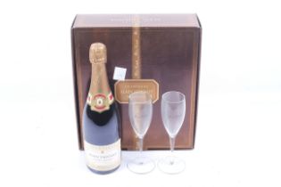 A bottle of Alain Thienot champagne. In original box complete with two glasses, 75cl, 12% vol.