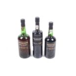 Three bottles of Cockburn's Special Reserve port.