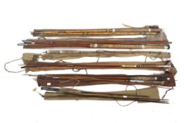 A collection of vintage fishing rods plus a landing net.