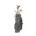 A collection of vintage golf clubs and golf bag.