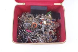 A collection of costume jewellery in a tan case