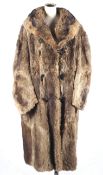 A vintage full length fur trench coat, possibly raccoon.