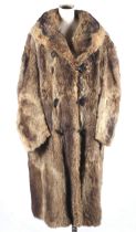 A vintage full length fur trench coat, possibly raccoon.