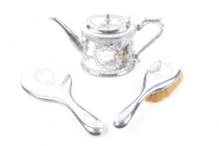 A silver backed mirror and a brush and silver-plated oval teapot.