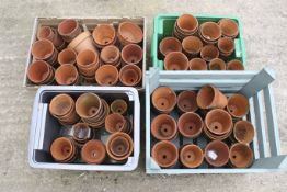A large collection of assorted terracotta garden flower pots. In four crates, various sizes.