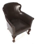 A small early 20th century brown leather 'club' style studded chair.