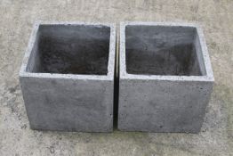 Two concrete square garden planters.