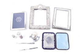 A collection of silver and silver mounted items including three photograph frames.