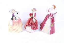 Three Royal Doulton lady figures.