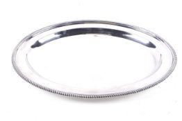 A Carrington & Co Ltd silver-plated oval tray with a gadrooned border.
