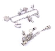 A pair of silver charm bracelets with twelve charms