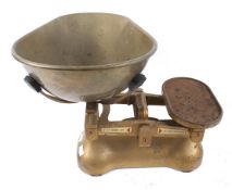 A vintage set of grocer's weighing scales. By W & T Avery Ltd of Birmingham, with a mat gold finish.