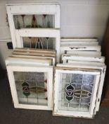 A collection of stained glass windows in white frames.