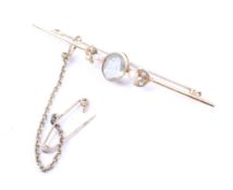 An early 20th century gold, pale aquamarine and seed-pearl three stone bar brooch.