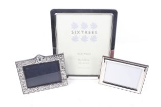 A vintage embossed silver mounted rectangular photograph frame and two others.