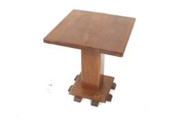 A square top Art Deco style mahogany coffee table. Having a square pedestal on a raise square base.