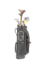 A collection of vintage golf clubs and golf bag.