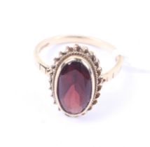A vintage 9ct gold and oval garnet single stone ring. Birmingham convention hallmarks, size K, 2.