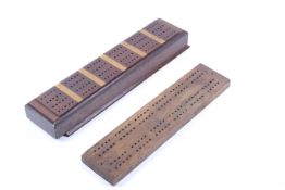 A set of early 20th century ebony and bone dominoes and two cribbage boards.