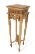 A carved wooden jardiniere stand.