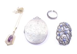 A small group of jewellery including an open oval brooch set with navy-blue pastes and marcasites.