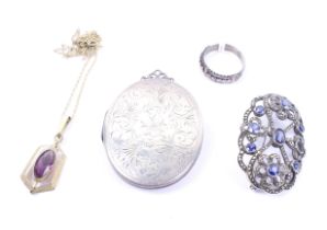 A small group of jewellery including an open oval brooch set with navy-blue pastes and marcasites.