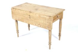 A Victorian drop leaf pine table.