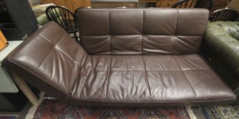 A Ligne Roset Smala brown leather sofa bed. Raised on metal support.
