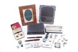 A collection of assorted items including fountain pens and watches