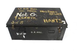 A vintage metal trunk and contents. With twin handles and marked 'D.R.