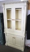 A contemporary French distressed style painted dresser cupboard.