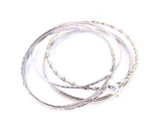 A group of six silver and yellow metal ladies bangles
