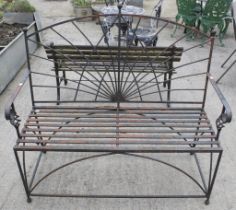 Wrought iron ornamental two seater garden bench.