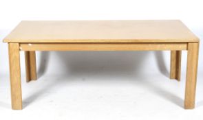 A large extending Lubke blonde oak rectangular dining table.