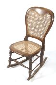 An early 20th century bergere chair, converted to a rocking chair.