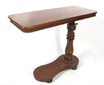 A Victorian mahogany adjustable bedside tray table.