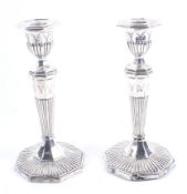 A pair of late Victorian silver octagonal candle sticks.