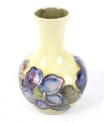 Moorcroft Clematis bud vase on yellow background, potters to the late Queen Mary sticker to base.