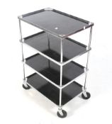 A mid-century chrome drinks trolley. With four tiers with black gloss bases, black plastic wheels.