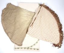 Three vintage bedspreads. Comprising a cream example with green tassels, 275cm x 265cm.