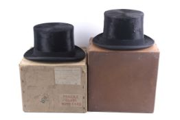 Two Lincoln Bennett & Co black silk top hats and a pair of gloves.