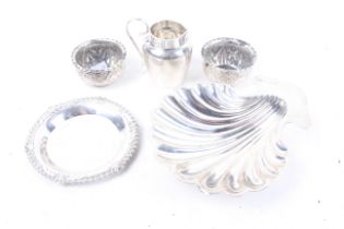 A silver butter shell and other items.