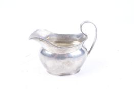 A silver oval milk jug.