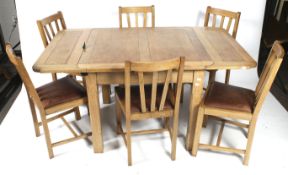 A circa 1940s oak draw leaf dining table and six matching chairs.