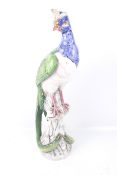 An late 19th early 20th century large decorative ceramic bird of paradise figure.