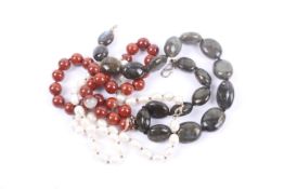 A collection of three necklaces including cultured pearl,