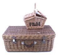 Two traditional wicker picnic baskets. including a hamper and a Fortnum & Mason basket.