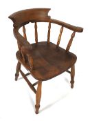 A late 19th or early 20th century smokers bow open armchair.