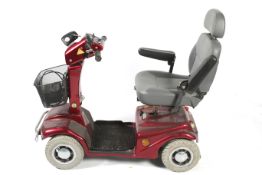 A Rascal 388XL red mobility scooter. With key, charger, no instructions. Some wear.