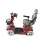 A Rascal 388XL red mobility scooter. With key, charger, no instructions. Some wear.